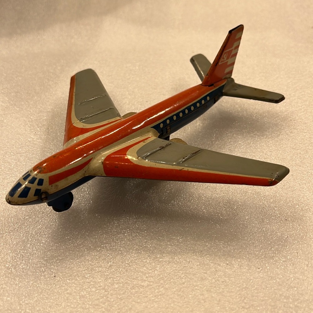 Vintage tin airplane in good shape.